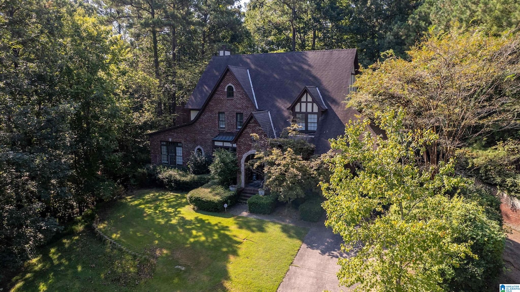 tudor-style house with a front lawn