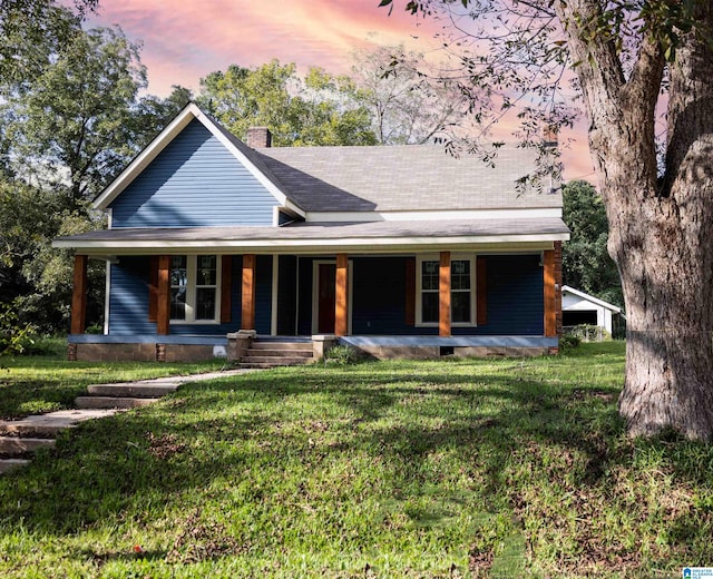 view of front of house featuring a lawn and a porch