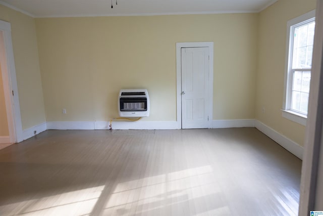 334 Ashland Ave, Wadley, AL 36276 - unfurnished room featuring heating unit, plenty of natural light, light wood-type flooring, and crown molding