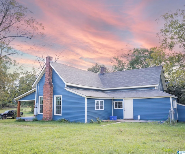 view of front of property with a garage and a yard