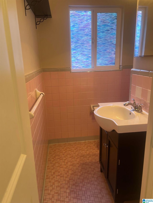 bathroom featuring tile walls and vanity