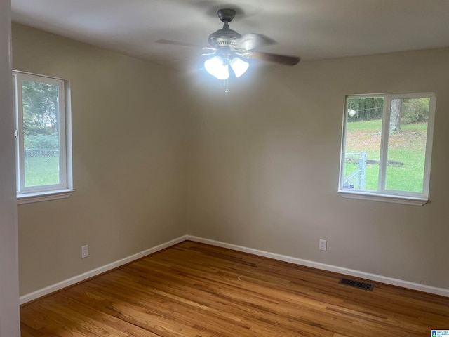 spare room featuring light hardwood / wood-style floors and ceiling fan