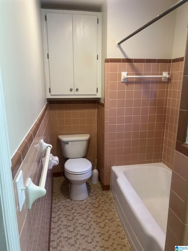 bathroom with tile walls and toilet