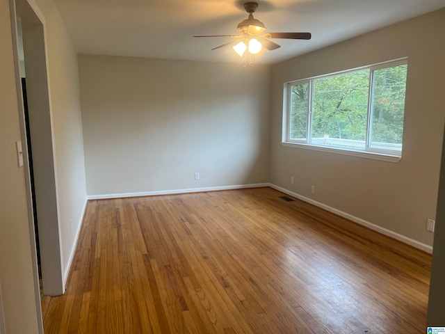 empty room featuring light wood-type flooring and ceiling fan