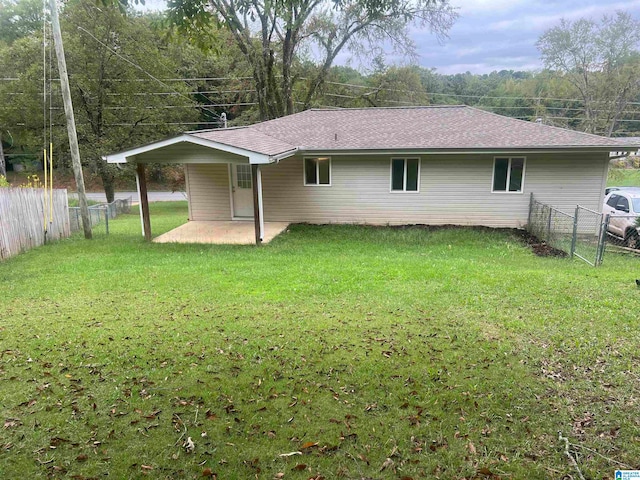 back of property featuring a lawn and a patio area