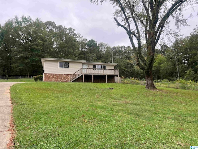 manufactured / mobile home with a deck and a front lawn