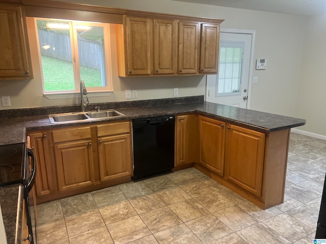 kitchen featuring black appliances, kitchen peninsula, and sink