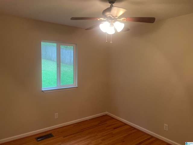 unfurnished room with ceiling fan and wood-type flooring