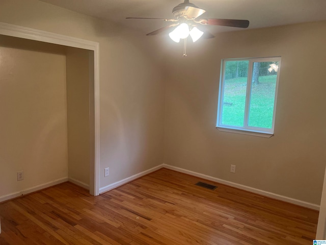 empty room featuring ceiling fan and light wood-type flooring