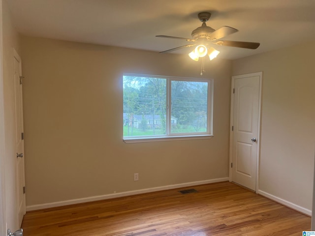 spare room with light wood-type flooring and ceiling fan