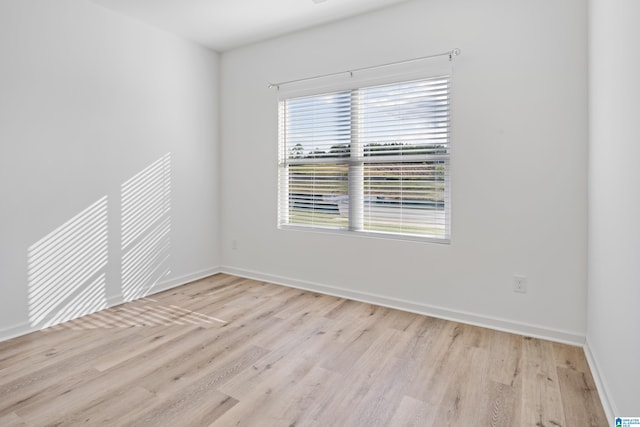 unfurnished room with light hardwood / wood-style floors