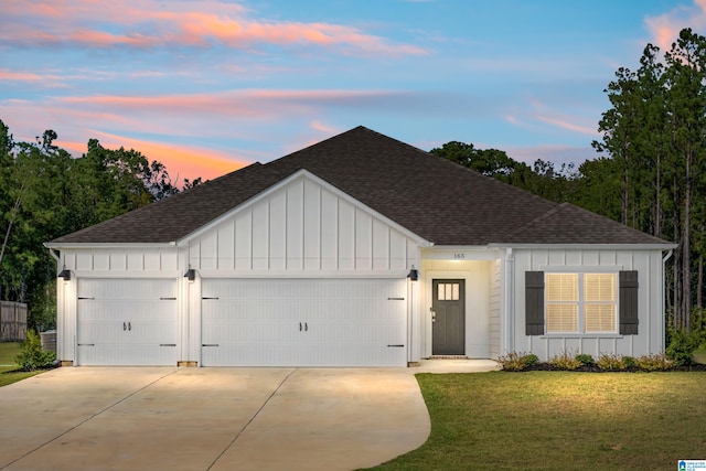 view of front of house featuring a garage and a lawn