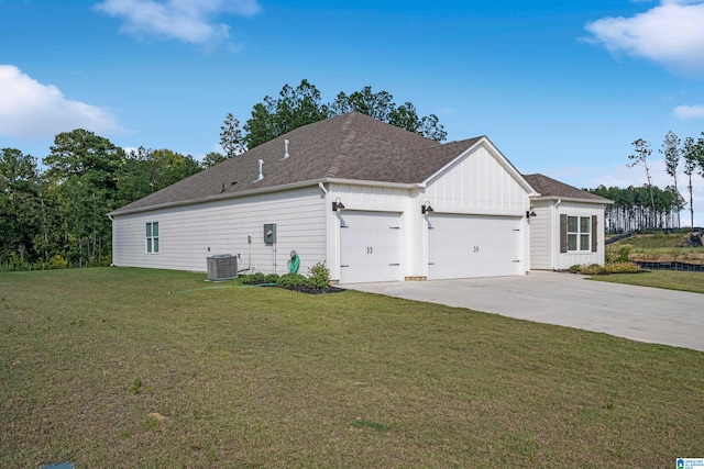 view of side of home featuring cooling unit, a yard, and a garage