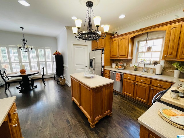 kitchen featuring a kitchen island, appliances with stainless steel finishes, sink, and dark hardwood / wood-style flooring