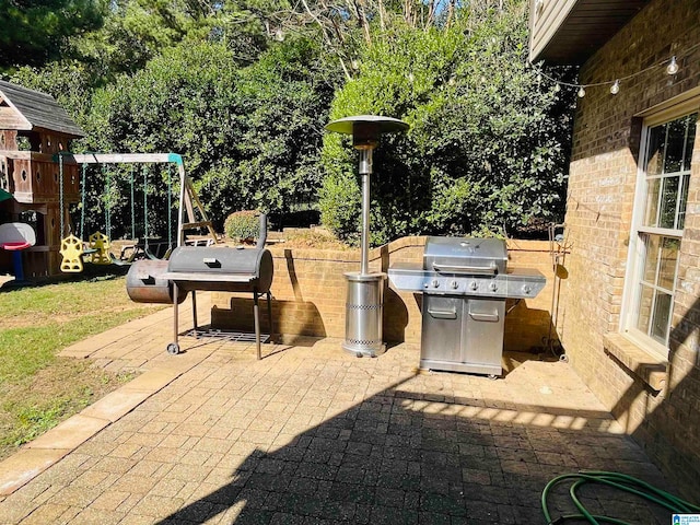 view of patio / terrace with a playground and a grill