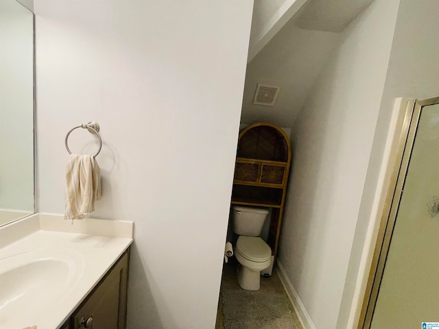 bathroom featuring toilet, a shower with door, and vanity