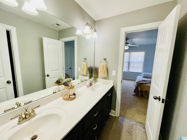 bathroom featuring hardwood / wood-style flooring, vanity, and ceiling fan