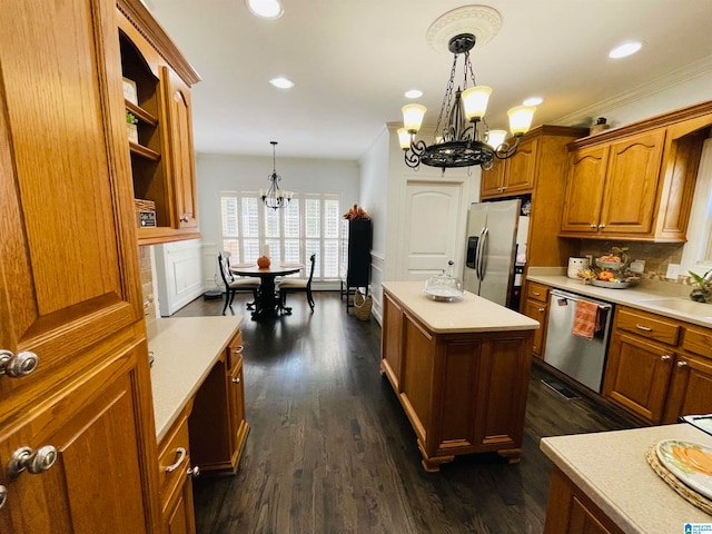 kitchen with stainless steel appliances, hanging light fixtures, dark hardwood / wood-style floors, and a chandelier