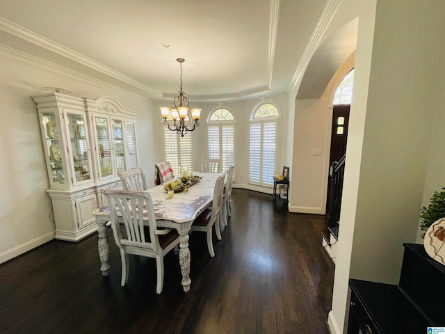 dining space with an inviting chandelier, crown molding, and dark hardwood / wood-style flooring