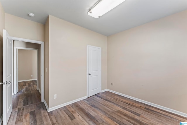 spare room featuring dark hardwood / wood-style floors