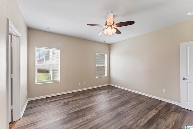 unfurnished room with ceiling fan and dark wood-type flooring