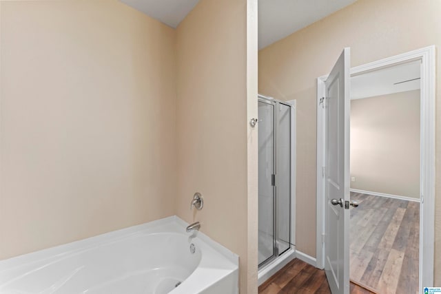 bathroom with wood-type flooring and separate shower and tub