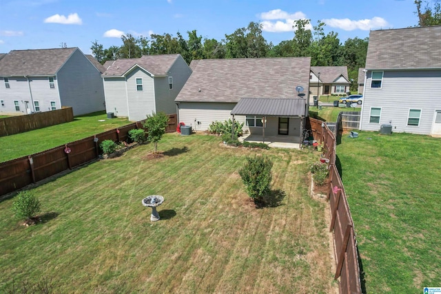 back of house featuring a lawn, cooling unit, and a patio