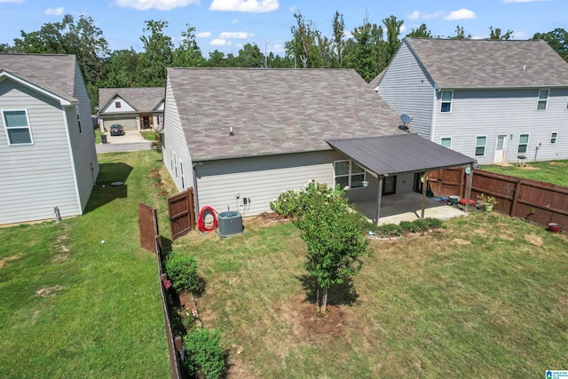 back of property with a yard, central AC unit, and a patio area