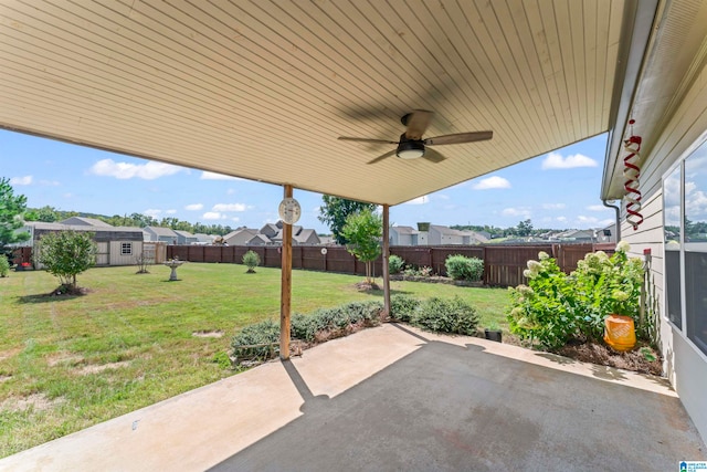 view of patio featuring ceiling fan and a storage unit