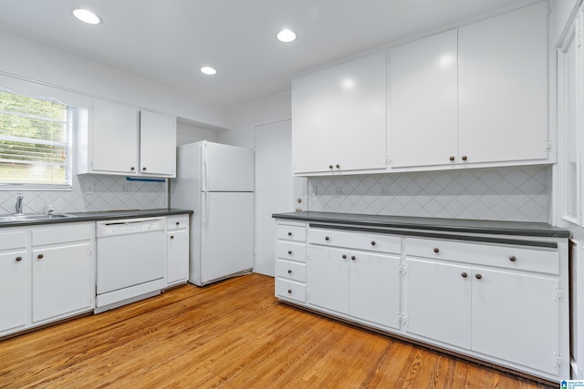 kitchen featuring light hardwood / wood-style floors, tasteful backsplash, sink, white cabinetry, and white appliances