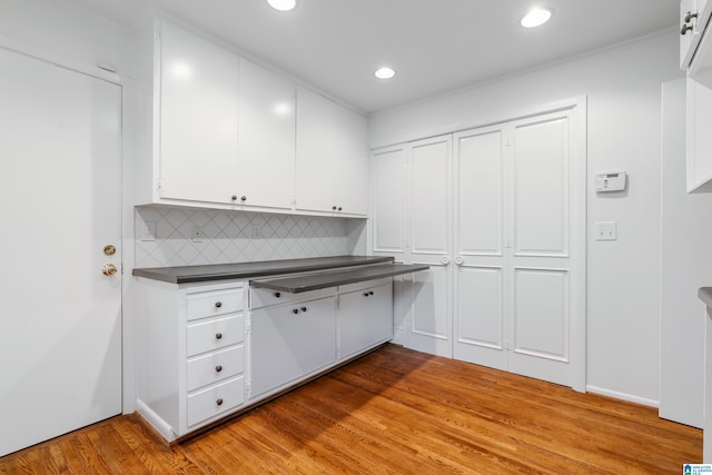 kitchen featuring white cabinets, backsplash, and light hardwood / wood-style floors