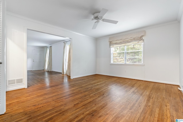 empty room featuring ornamental molding, hardwood / wood-style floors, and ceiling fan