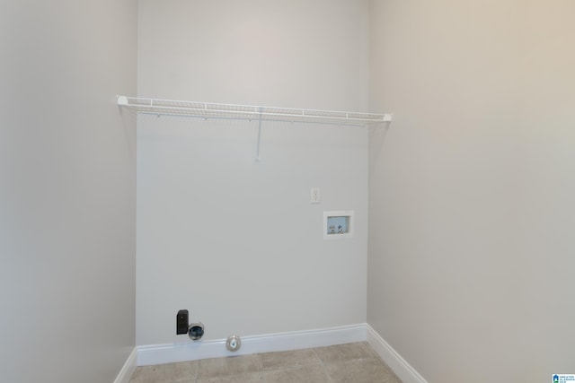 laundry area with hookup for a washing machine and light tile patterned floors