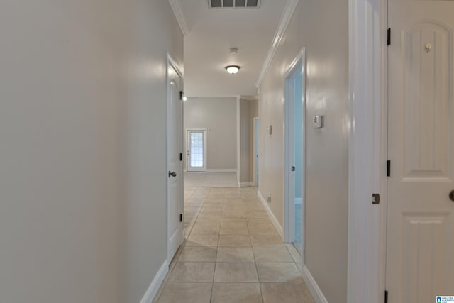 hall featuring crown molding and light tile patterned flooring