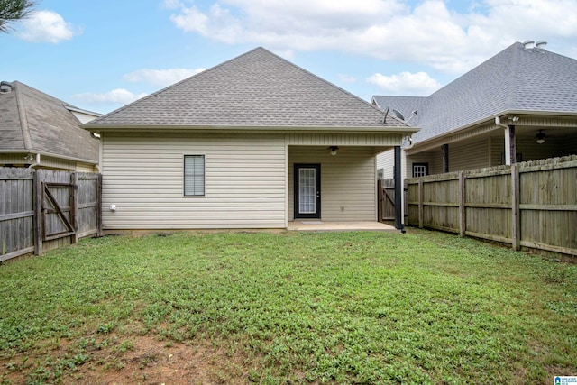 rear view of house with a yard and a patio area