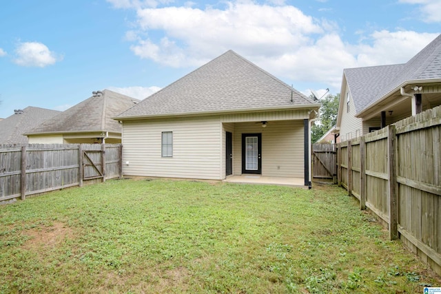 rear view of house featuring a yard, ceiling fan, and a patio area