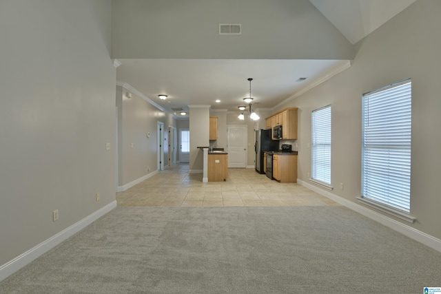 kitchen featuring light carpet, decorative light fixtures, crown molding, and a kitchen island