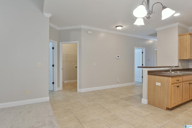 kitchen with sink, a notable chandelier, hanging light fixtures, light brown cabinets, and crown molding