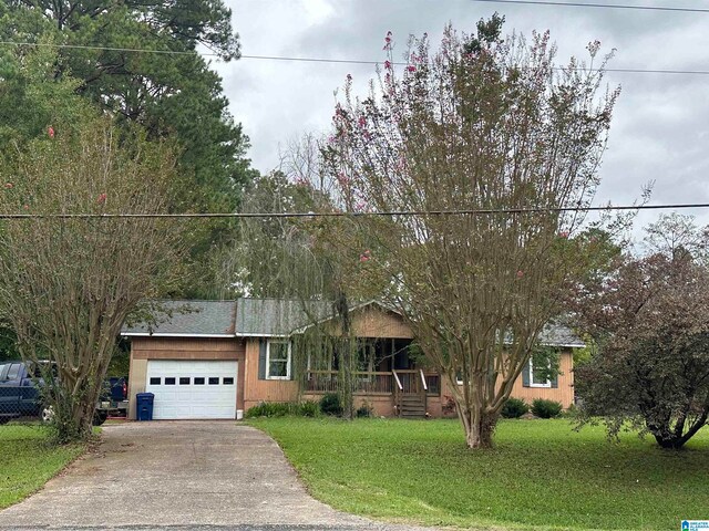 ranch-style home with a garage and a front lawn