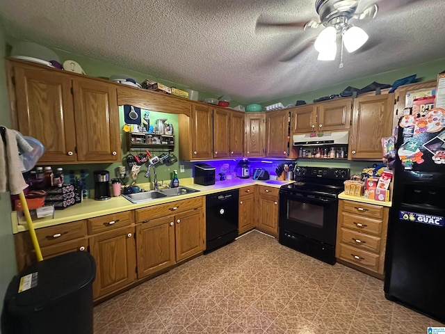 kitchen with a textured ceiling, black appliances, sink, and ceiling fan