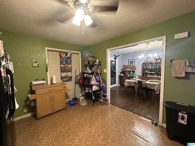 miscellaneous room featuring a textured ceiling, ceiling fan with notable chandelier, and light hardwood / wood-style flooring