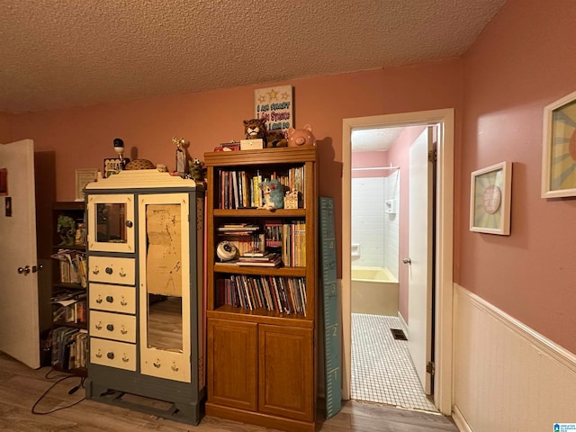 interior space featuring a textured ceiling and hardwood / wood-style floors