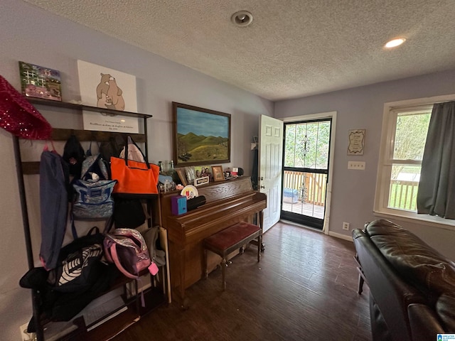 misc room with a textured ceiling and hardwood / wood-style flooring