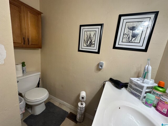 bathroom with tile patterned flooring and toilet