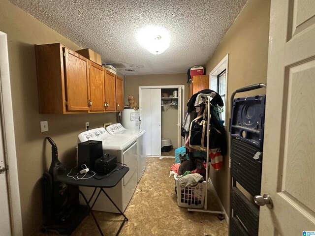 washroom with washing machine and clothes dryer, a textured ceiling, cabinets, and gas water heater