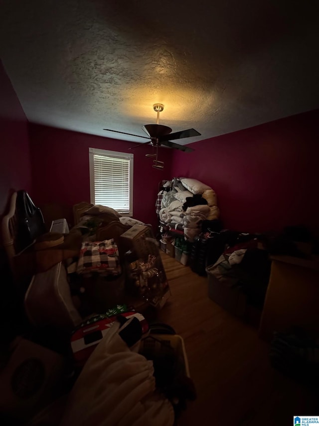 bedroom featuring a textured ceiling and ceiling fan