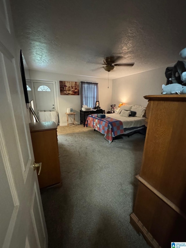 bedroom featuring a textured ceiling, carpet flooring, and ceiling fan