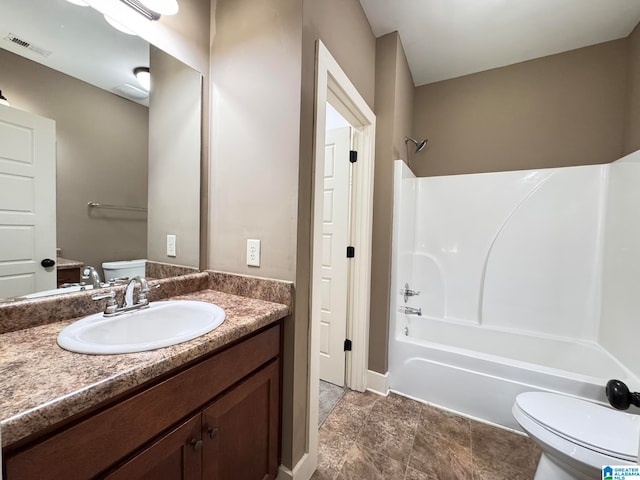 full bathroom with  shower combination, vanity, and toilet