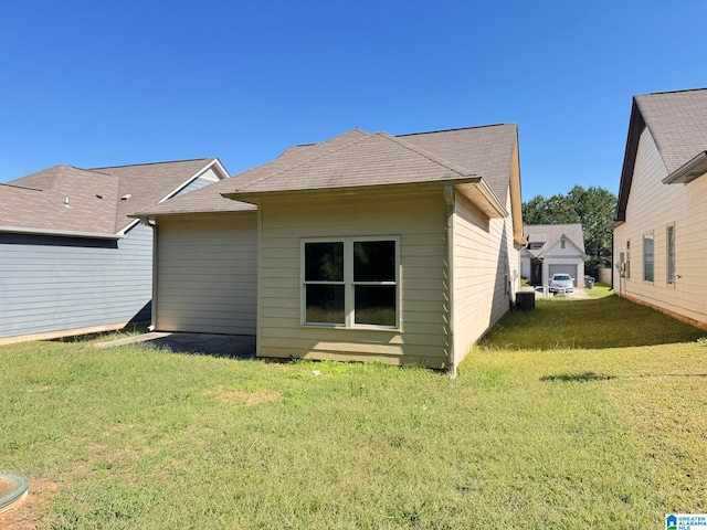 rear view of property with a yard and cooling unit