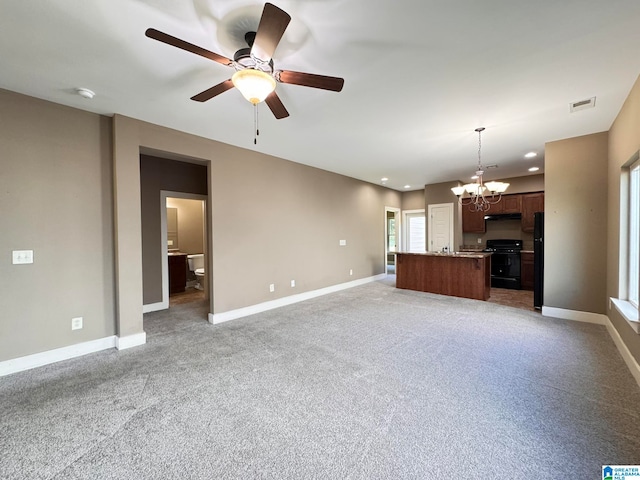 unfurnished living room with light colored carpet and ceiling fan with notable chandelier